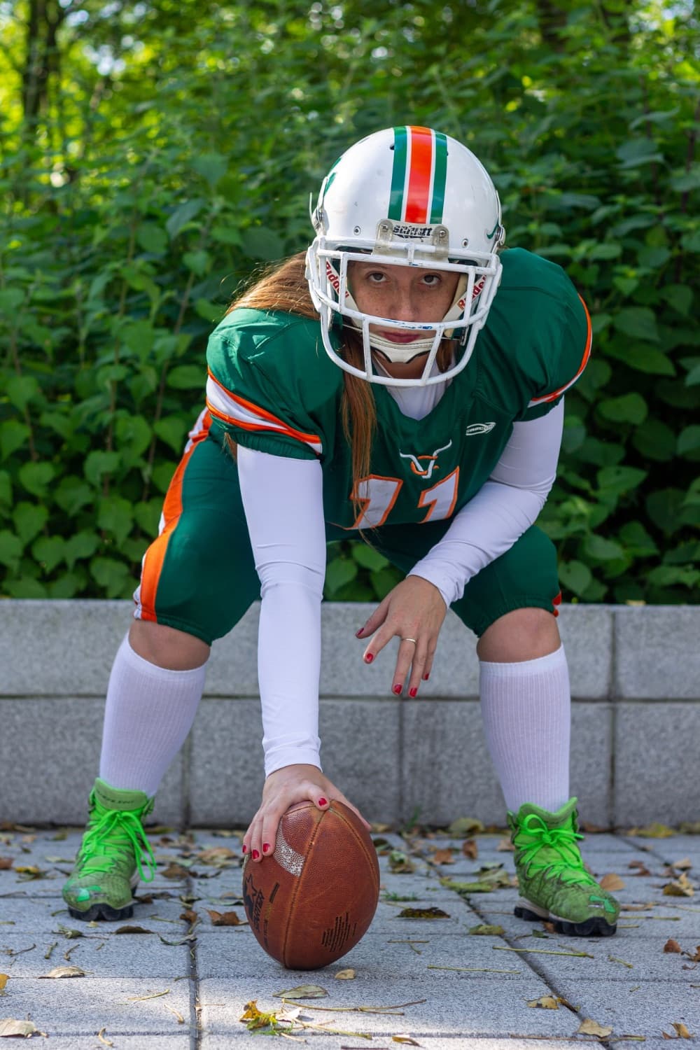 Football player set over the ball in a custom jersey