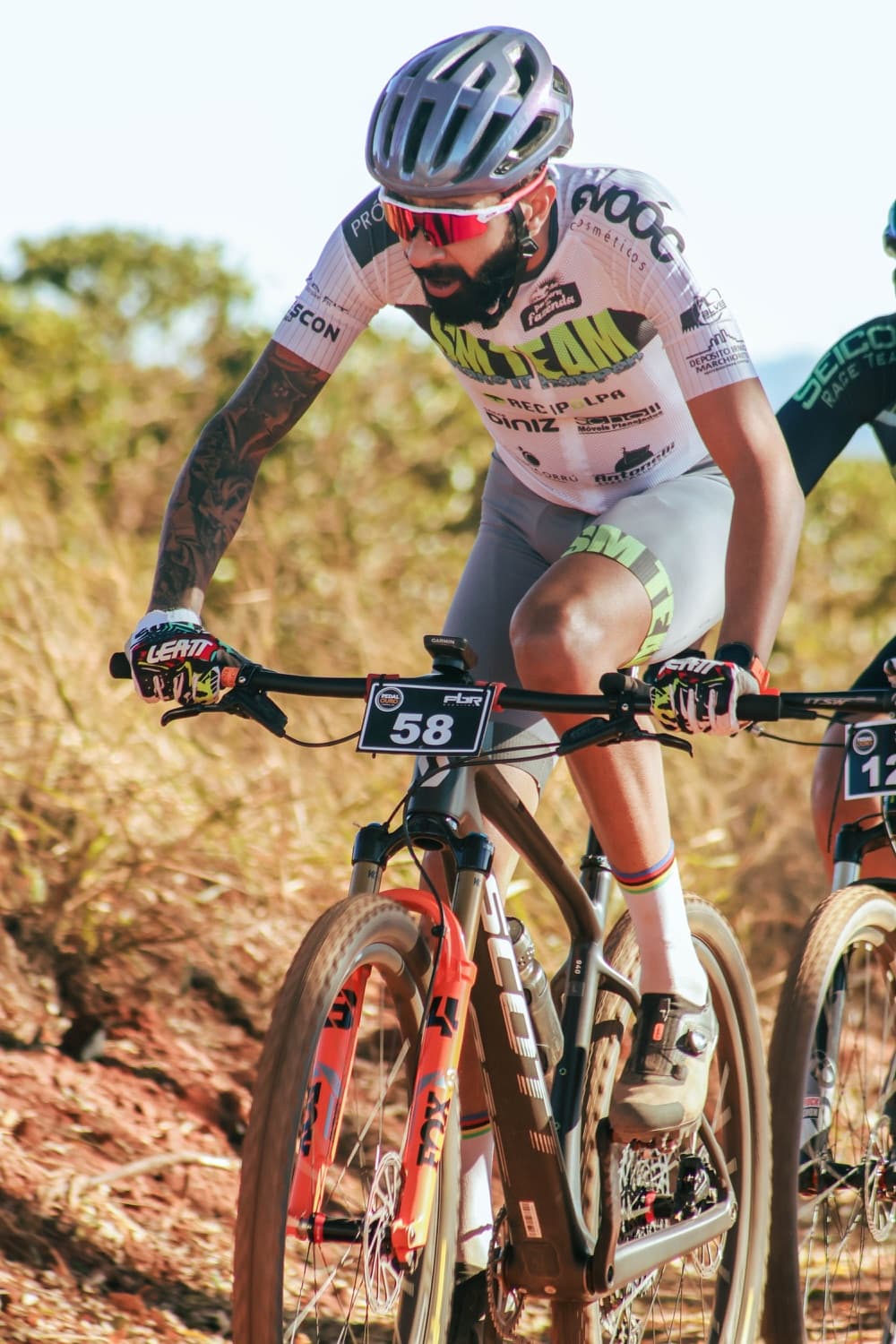 Cyclist climbing in a printed team kit