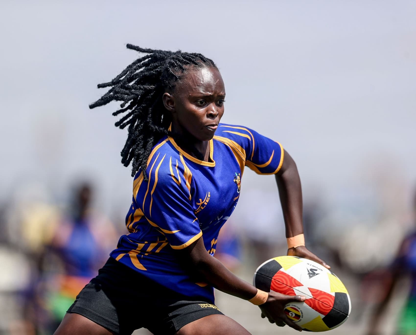 Rugby player carrying the ball in a custom jersey