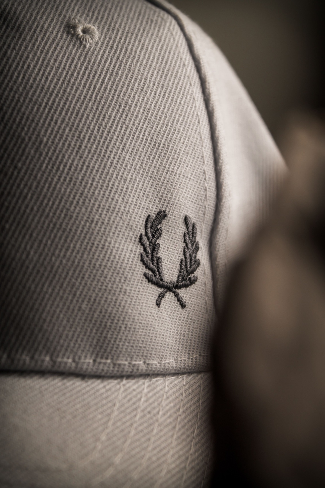 Close-up of an embroidered emblem on a cotton cap